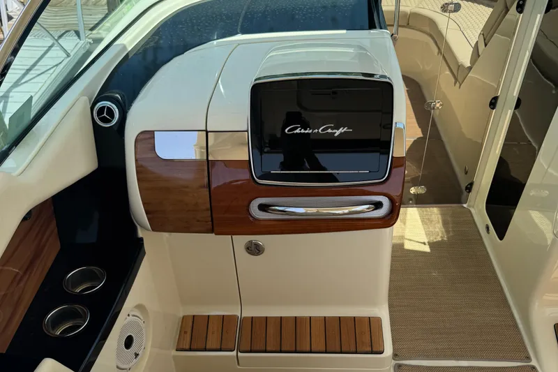 Slide: The Image of 2020 Chris-Craft Launch 31 GT dashboard with wood accents and sleek design. - 80