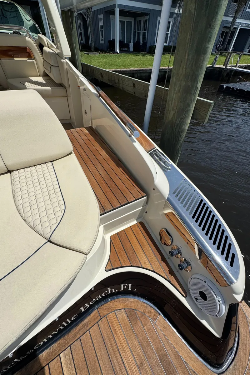 Slide: The Image of 2020 Chris-Craft Launch 31 GT boat with elegant seating and wooden deck details. - 82