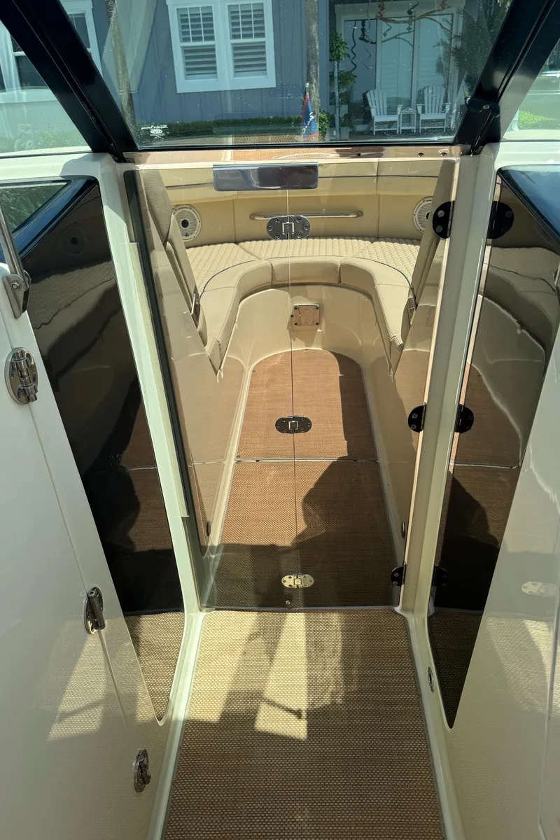 Slide: The Image of 2020 Chris-Craft Launch 31 GT interior with beige seating and carpeted flooring. - 86