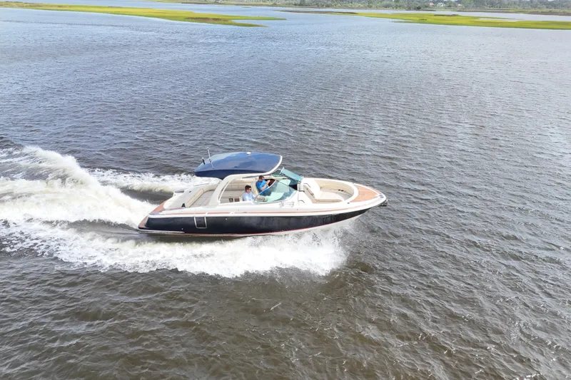 Slide: The Image of 2020 Chris-Craft Launch 31 GT cruising on open water, showcasing sleek design and performance. - 9