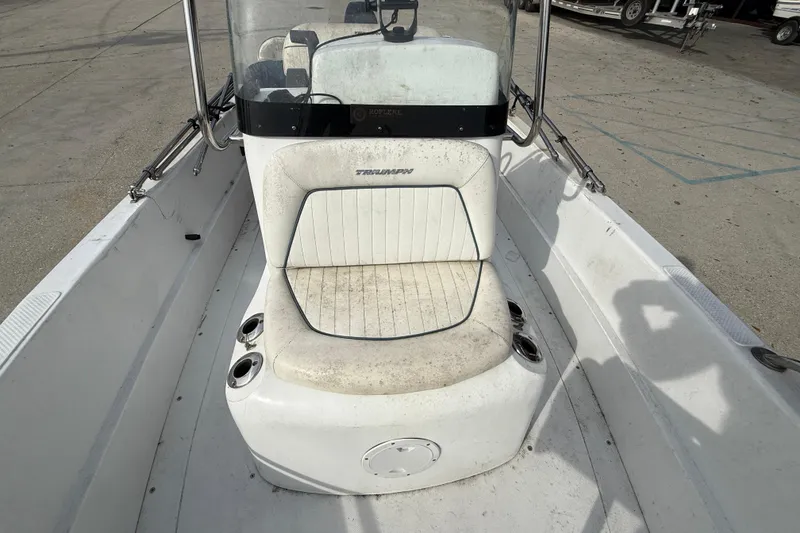Slide: The Image of 2007 Triumph 170CC boat interior with white seating and console. - 12