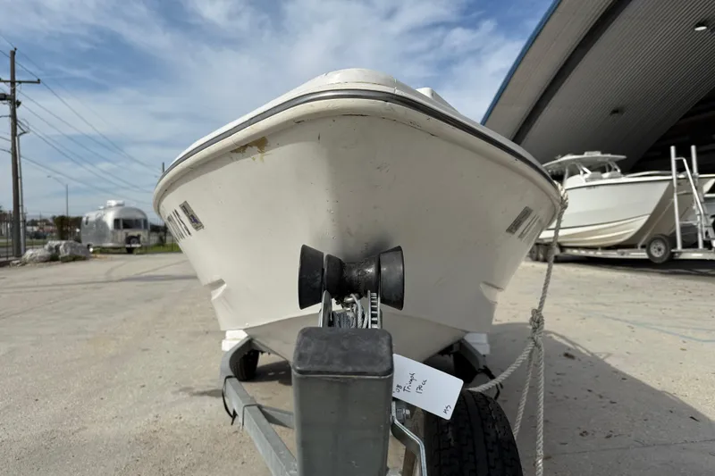 Slide: The Image of 2007 Triumph 170CC boat on trailer, parked outdoors near a storage facility. - 3