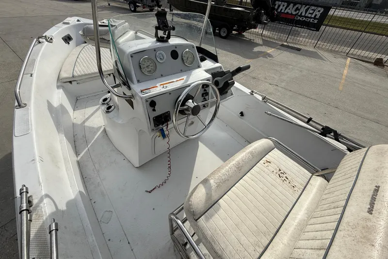 Slide: The Image of 2007 Triumph 170CC boat interior with steering wheel and seating, parked outdoors. - 9