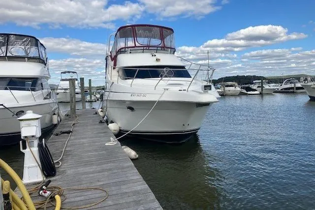 The Image of 2006 Silverton 39 Motor Yacht docked at marina under blue sky. - 0