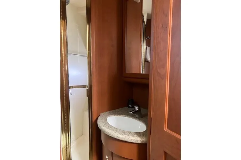 Slide: The Image of Bathroom interior of 2006 Silverton 39 Motor Yacht with wooden cabinetry and sink. - 11