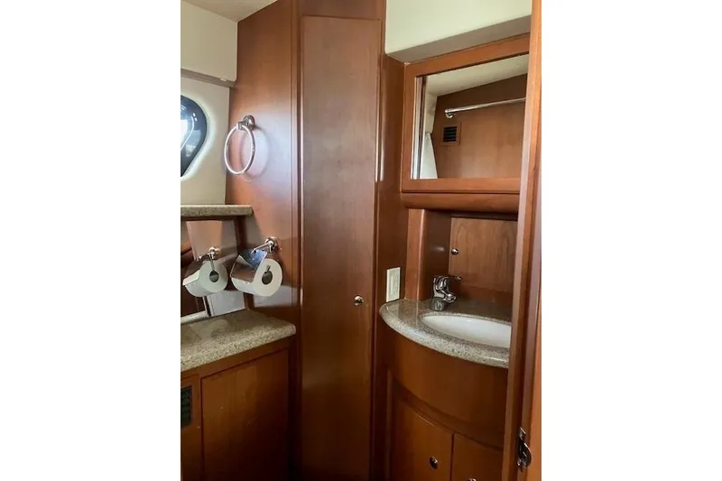 Slide: The Image of 2006 Silverton 39 Motor Yacht bathroom with wood cabinetry and sink. - 13