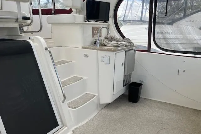 Slide: The Image of 2006 Silverton 39 Motor Yacht interior with stairs, sink, and TV. - 2