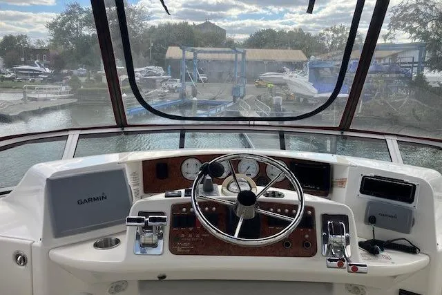 Slide: The Image of 2006 Silverton 39 Motor Yacht helm with Garmin navigation, docked at marina. - 5