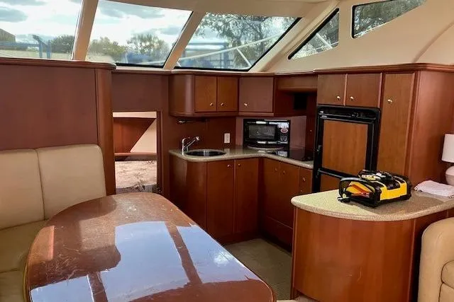 Slide: The Image of Interior of 2006 Silverton 39 Motor Yacht with wood cabinetry and modern amenities. - 6