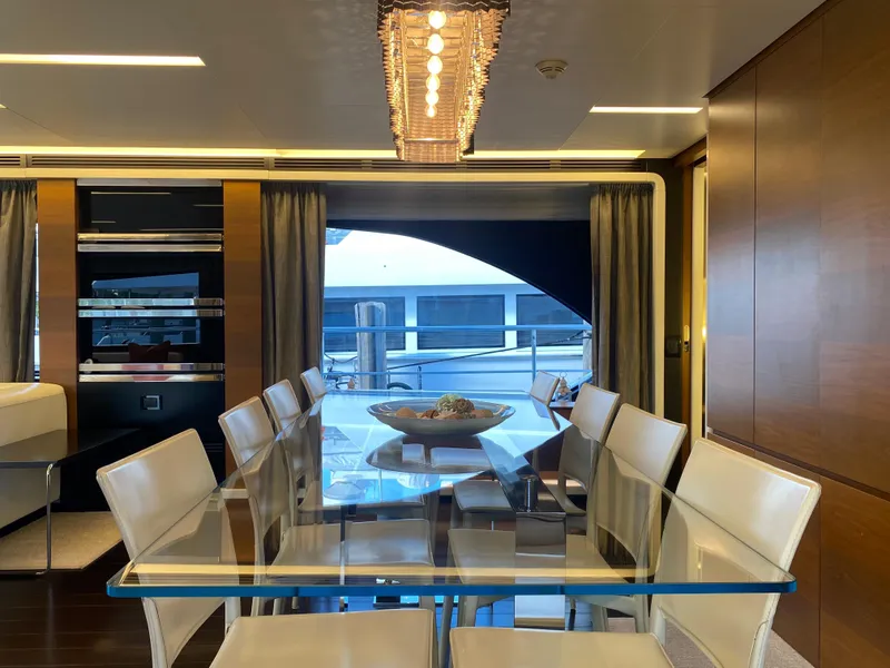 Slide: The Image of Luxurious dining area on a 2014 Azimut 100 Grande yacht with glass table and modern decor. - 17
