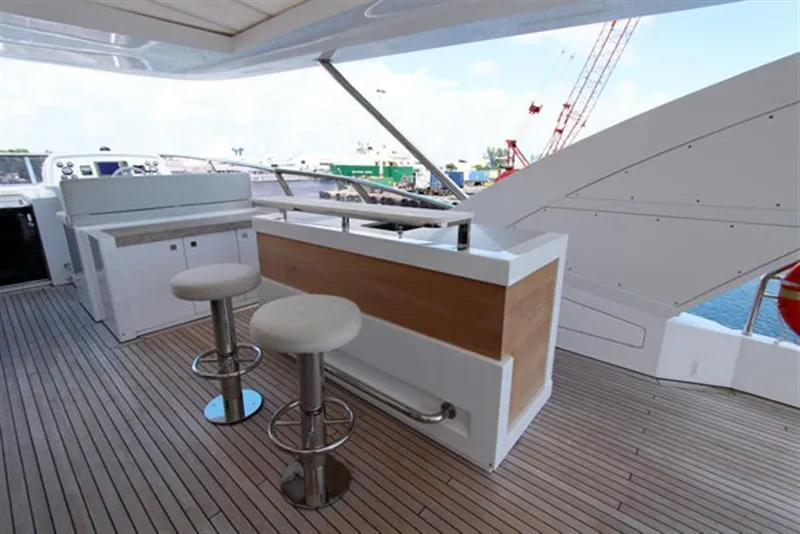Slide: The Image of Outdoor bar area on 2014 Azimut 100 Grande yacht with stools and wooden deck. - 4