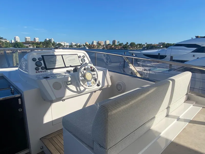 Slide: The Image of Helm station of 2014 Azimut 100 Grande yacht with city skyline in background. - 42
