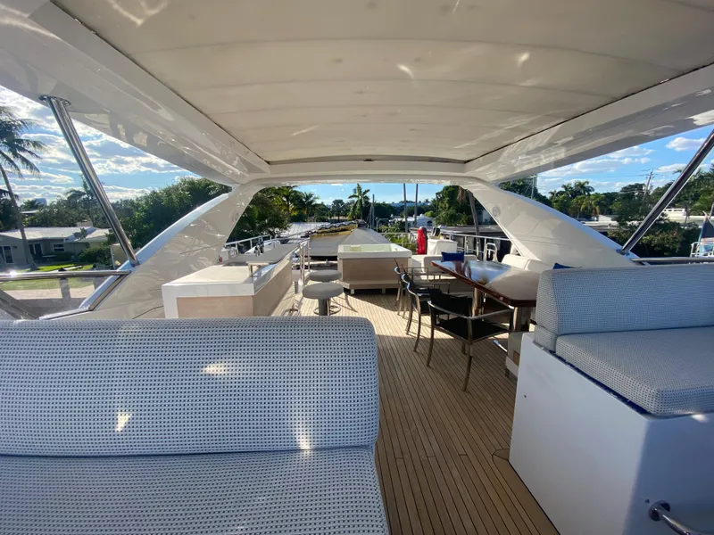 Slide: The Image of 2014 Azimut 100 Grande yacht deck with seating and dining area. - 44