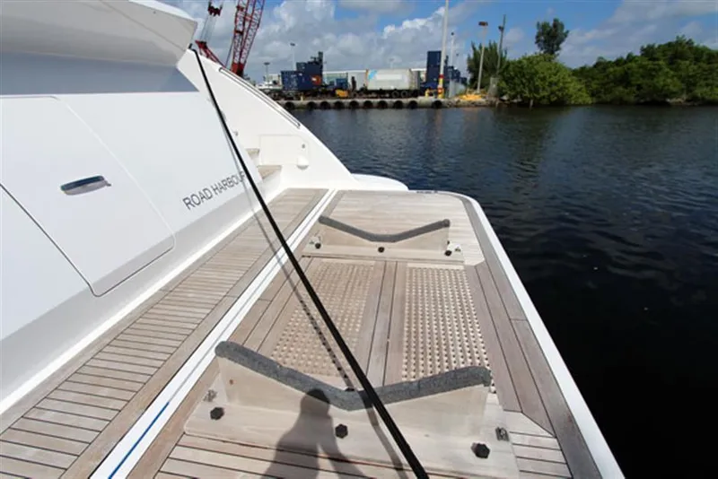 Slide: The Image of Azimut 100 Grande 2014 yacht deck with water and dock in the background. - 8
