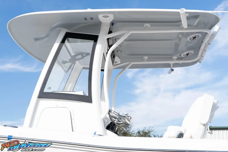 Slide: The Image of 2026 Sea Hunt Gamefish 25 boat with T-top and speakers against blue sky. - 11