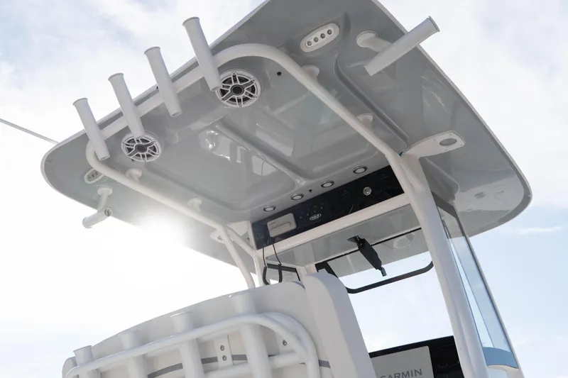 Slide: The Image of 2026 Sea Hunt Gamefish 25 boat with T-top and rod holders under a bright sky. - 14