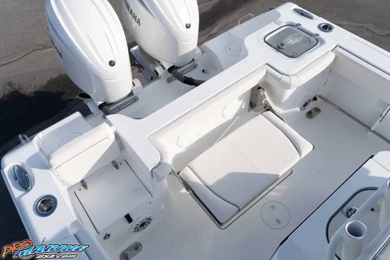 Slide: The Image of 2026 Sea Hunt Gamefish 25 boat interior with Yamaha engines, featuring seating and storage. - 17