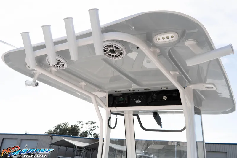 Slide: The Image of 2026 Sea Hunt Gamefish 25 T-top with rod holders and speakers, outdoor setting. - 19