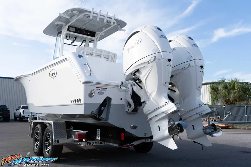 Slide: The Image of 2026 Sea Hunt Gamefish 25 boat with dual Yamaha outboard engines on a trailer. - 2