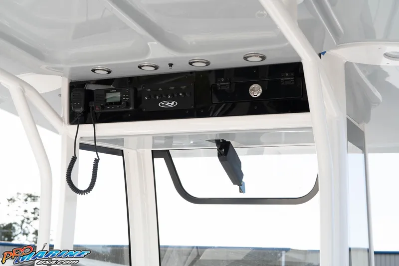 Slide: The Image of 2026 Sea Hunt Gamefish 25 console with electronics and storage compartment. - 20