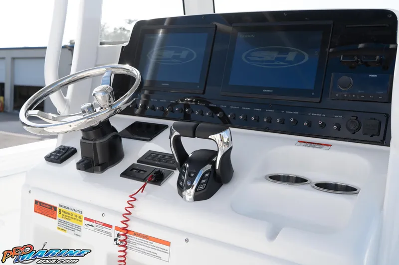 Slide: The Image of Control panel of 2026 Sea Hunt Gamefish 25 boat with steering wheel and displays. - 21