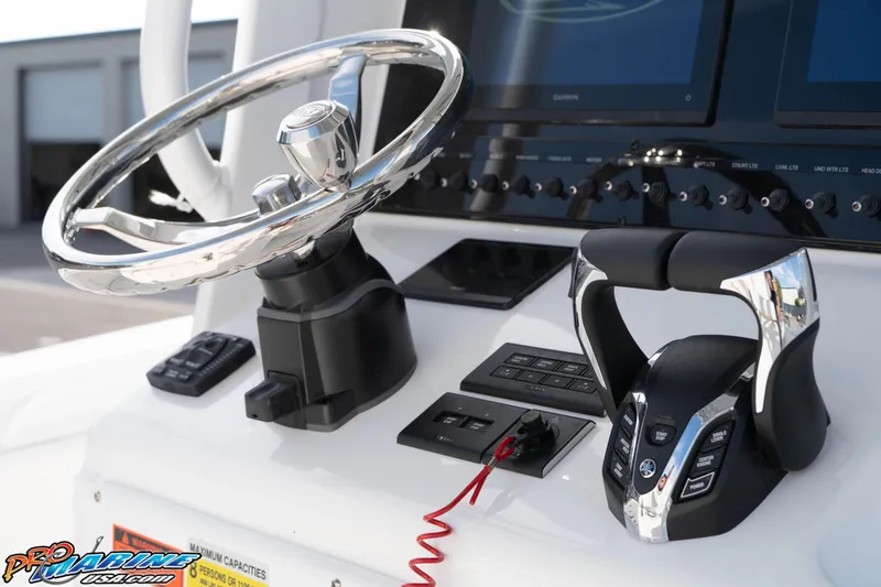 Slide: The Image of 2026 Sea Hunt Gamefish 25 helm with modern steering wheel and control panel. - 22