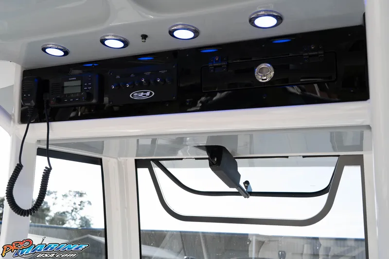 Slide: The Image of 2026 Sea Hunt Gamefish 25 boat console with electronics and lighting. - 23