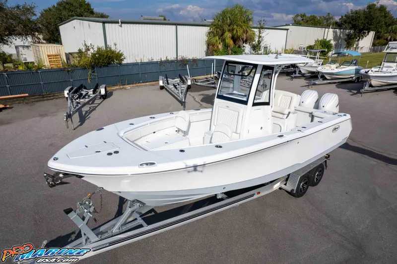 Slide: The Image of 2026 Sea Hunt Gamefish 25 boat on trailer in outdoor setting. - 26