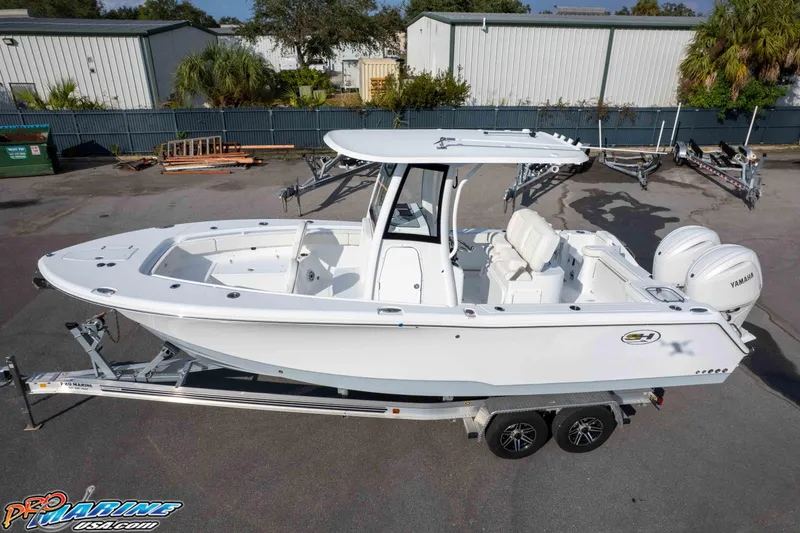 Slide: The Image of 2026 Sea Hunt Gamefish 25 boat on trailer, featuring dual Yamaha engines. - 31