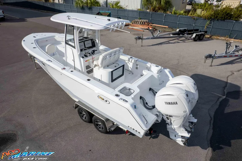 Slide: The Image of 2026 Sea Hunt Gamefish 25 boat with dual Yamaha engines, parked on a trailer. - 32