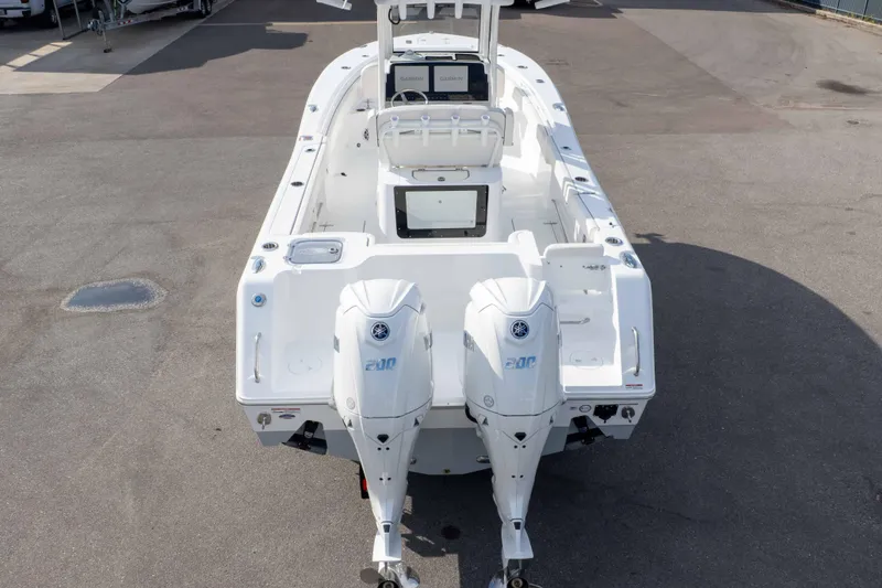 Slide: The Image of 2026 Sea Hunt Gamefish 25 boat with dual outboard engines, viewed from the rear. - 33