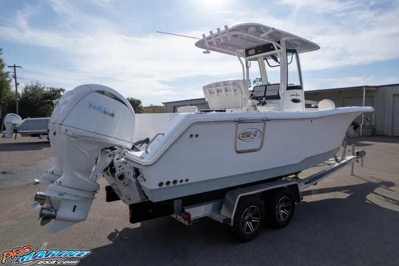 Slide: The Image of 2026 Sea Hunt Gamefish 25 boat on trailer, featuring Yamaha outboard motor. - 34