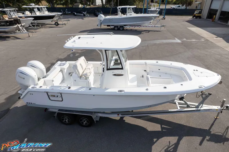 Slide: The Image of 2026 Sea Hunt Gamefish 25 boat on trailer in marina setting. - 36