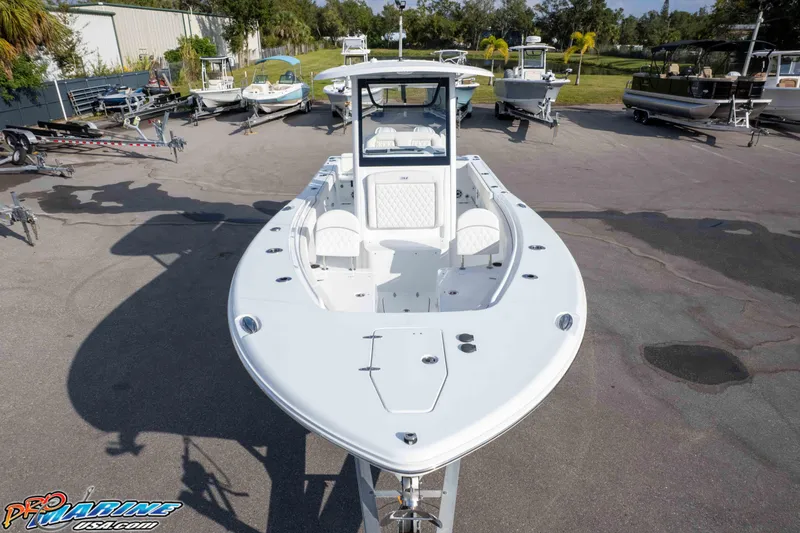 Slide: The Image of 2026 Sea Hunt Gamefish 25 boat displayed in a marina with other vessels. - 38