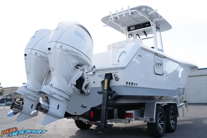 Slide: The Image of 2026 Sea Hunt Gamefish 25 boat with dual Yamaha outboard engines on a trailer. - 5