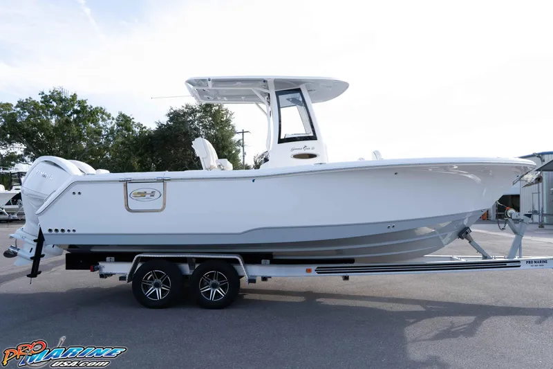 Slide: The Image of 2026 Sea Hunt Gamefish 25 boat on trailer, side view, outdoors. - 6