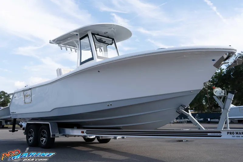 Slide: The Image of 2026 Sea Hunt Gamefish 25 boat on trailer under clear sky. - 7