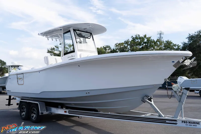 Slide: The Image of 2026 Sea Hunt Gamefish 25 boat on trailer, displayed outdoors. - 8