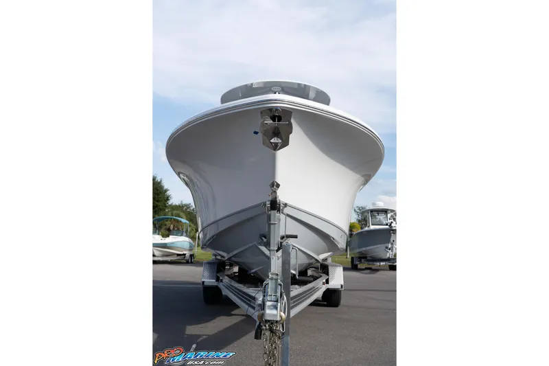 Slide: The Image of 2026 Sea Hunt Gamefish 25 boat on trailer, front view, parked outdoors. - 9