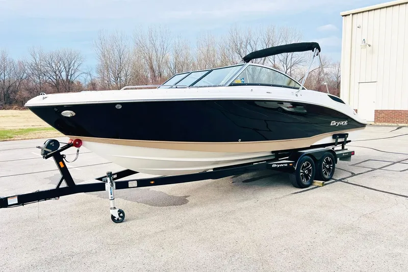 Slide: The Image of 2019 Bryant Potenza boat on trailer, black and white design, parked outdoors. - 2