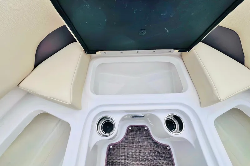 Slide: The Image of 2019 Bryant Potenza boat interior with open storage compartment and cup holders. - 21