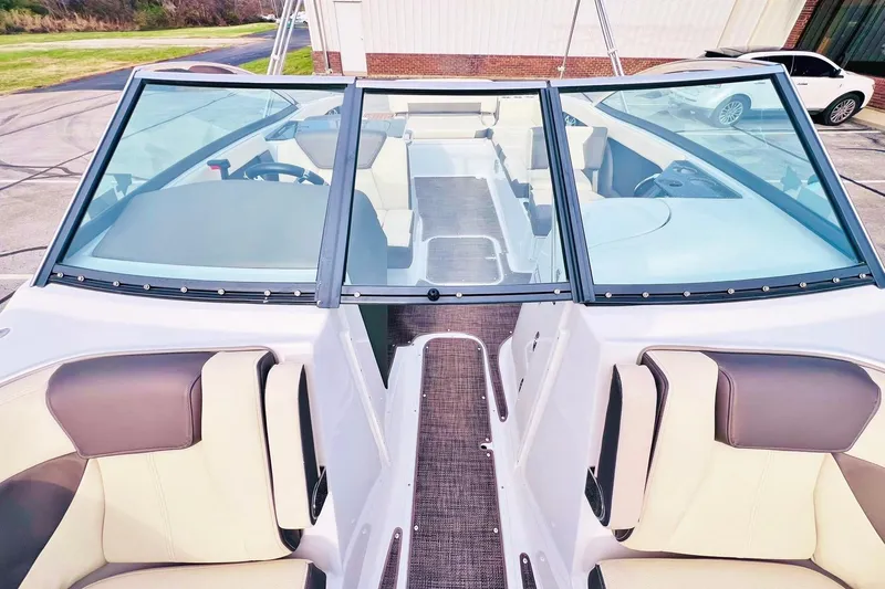 Slide: The Image of 2019 Bryant Potenza boat interior with beige and brown seating, clear windshield. - 25