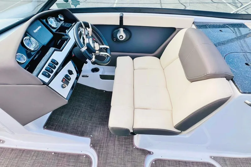 Slide: The Image of 2019 Bryant Potenza boat interior with steering wheel and beige seating. - 26