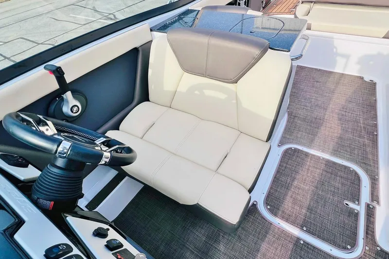 Slide: The Image of 2019 Bryant Potenza boat interior with steering wheel and beige seating. - 37