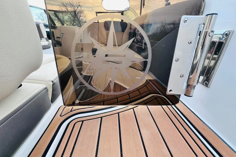 Slide: The Image of 2019 Bryant Potenza boat interior with logo on glass door, featuring sleek design and wood flooring. - 47