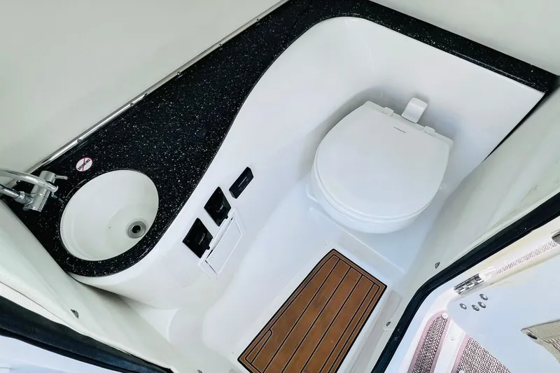 Slide: The Image of 2019 Bryant POTENZA 270 boat bathroom with sink, toilet, and wooden floor panel. - 49