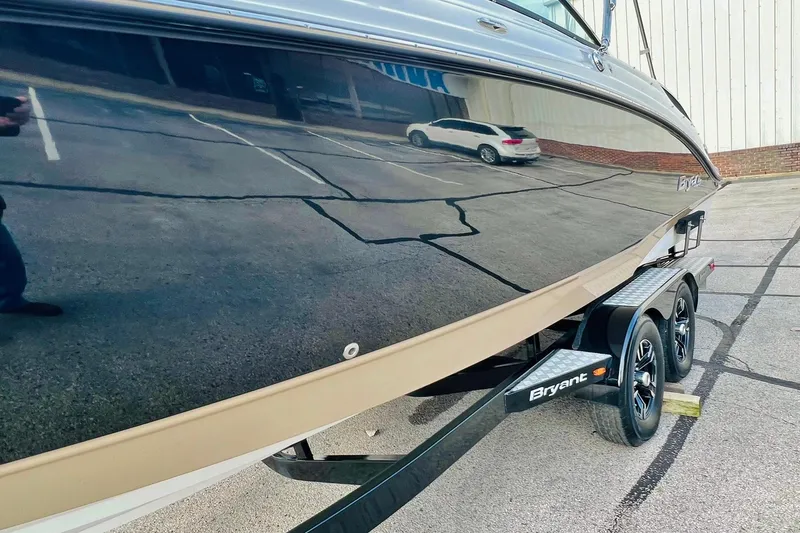 Slide: The Image of 2019 Bryant Potenza boat on trailer, reflecting parking lot and nearby vehicle. - 5
