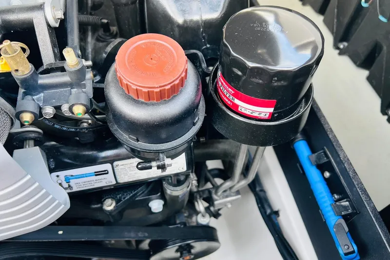 Slide: The Image of Close-up of a 2019 Bryant POTENZA 270 engine components, featuring oil filter and cap. - 57
