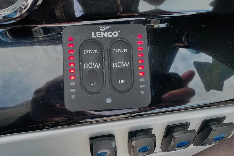 Slide: The Image of Control panel of a 2019 Bryant POTENZA 270 boat with Lenco trim tab switches. - 70