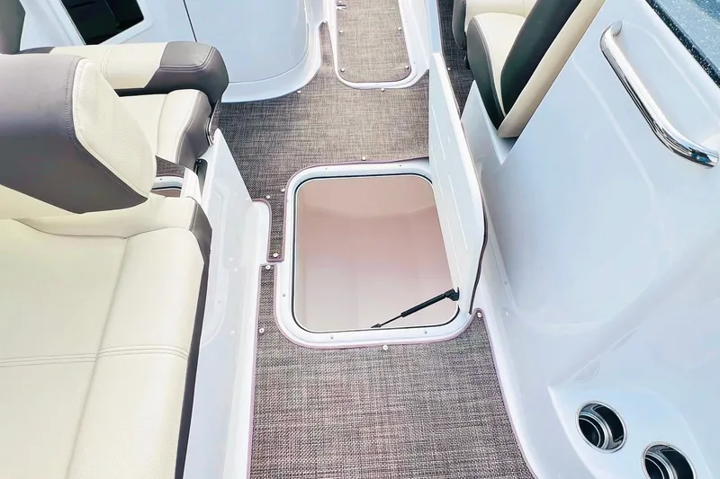 Slide: The Image of 2019 Bryant POTENZA 270 boat interior with open storage compartment and cushioned seating. - 73